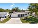 Charming single-story home with attached garage, front yard landscaping, and a covered entryway at 3410 Allandale Dr, Holiday, FL 34691