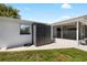 Exterior of home featuring backyard shed, screened patio, and partial fenced yard at 3410 Allandale Dr, Holiday, FL 34691