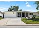 Well-maintained single-story home with manicured lawn and a charming facade during the day at 3410 Allandale Dr, Holiday, FL 34691