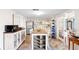 A cozy kitchen with white cabinetry, stainless steel appliances, and eat-in dining area at 3410 Allandale Dr, Holiday, FL 34691