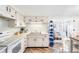 Bright kitchen with white cabinets, tile backsplash, and an open layout at 3410 Allandale Dr, Holiday, FL 34691