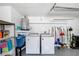 Bright and clean laundry area with newer appliances, shelving and hot water tank at 3410 Allandale Dr, Holiday, FL 34691