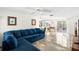 Open living area with a plush blue sectional sofa and views leading to the dining area and outdoor porch at 3410 Allandale Dr, Holiday, FL 34691