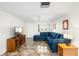 Bright living room featuring a comfortable blue sectional, tiled floors, and plenty of natural light at 3410 Allandale Dr, Holiday, FL 34691