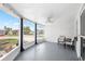 Inviting screened-in porch with a ceiling fan and lovely views of the surrounding neighborhood at 3410 Allandale Dr, Holiday, FL 34691