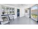 Cozy screened-in porch with comfortable seating and a ceiling fan, perfect for relaxing outdoors at 3410 Allandale Dr, Holiday, FL 34691