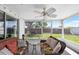 Relaxing screened-in porch with wicker seating and a ceiling fan, overlooking a private backyard at 3410 Allandale Dr, Holiday, FL 34691