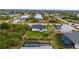 Aerial view of a modern home with a large yard, pool and a canal in the neighborhood at 10071 Kingsville Dr, Port Charlotte, FL 33981