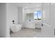 Modern bathroom showcasing a freestanding tub, white vanity, and large window for natural light at 10071 Kingsville Dr, Port Charlotte, FL 33981