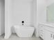 Minimalist bathroom design features a modern free-standing tub and sleek vanity at 10071 Kingsville Dr, Port Charlotte, FL 33981