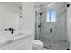 Modern bathroom features marble-look shower and tile floors, a white vanity, and black fixtures at 10071 Kingsville Dr, Port Charlotte, FL 33981