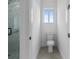Clean bathroom with a walk-in shower, toilet and neutral tiling at 10071 Kingsville Dr, Port Charlotte, FL 33981