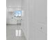 Bright bathroom featuring sleek white cabinets, marble countertops, and a window with a view at 10071 Kingsville Dr, Port Charlotte, FL 33981