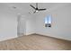Spacious bedroom with wood-look floors, a ceiling fan, and a large window at 10071 Kingsville Dr, Port Charlotte, FL 33981