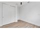 Bedroom features wood-look floors, a closet with white doors, and crisp white paint at 10071 Kingsville Dr, Port Charlotte, FL 33981