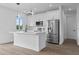 Beautiful kitchen with white cabinetry, stainless steel appliances, and an island, perfect for cooking at 10071 Kingsville Dr, Port Charlotte, FL 33981