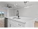 Modern kitchen island with white countertops, sink, and contemporary pendant lighting above at 10071 Kingsville Dr, Port Charlotte, FL 33981