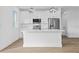 Modern kitchen with white cabinets, stainless steel appliances, and a large island for cooking at 10071 Kingsville Dr, Port Charlotte, FL 33981