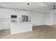 Modern kitchen featuring an island, stainless steel appliances, and stylish pendant lighting at 10071 Kingsville Dr, Port Charlotte, FL 33981
