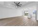 Bright, open-concept living room features wood-look floors, island kitchen, and sliding glass doors to the outdoors at 10071 Kingsville Dr, Port Charlotte, FL 33981