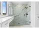 Modern walk-in shower with marble tiling and sleek fixtures, complemented by a marble countertop vanity at 10071 Kingsville Dr, Port Charlotte, FL 33981