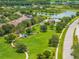 Aerial view of community park including pool and clubhouse, walking paths, and lake at 10720 Breaking Rocks Dr, Tampa, FL 33647