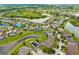 Stunning aerial view of a vibrant community with lush greenery, serene ponds, and beautiful homes with pools at 10720 Breaking Rocks Dr, Tampa, FL 33647