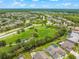 Aerial view of a planned community with green spaces, a playground, and well-maintained landscaping at 10720 Breaking Rocks Dr, Tampa, FL 33647