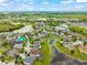Aerial view of a neighborhood with ponds and green spaces offering a tranquil living environment at 10720 Breaking Rocks Dr, Tampa, FL 33647