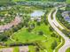 Aerial view of the community's manicured green space, pool and clubhouse and quiet walking paths at 10720 Breaking Rocks Dr, Tampa, FL 33647