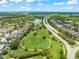 Aerial view showcases the proximity of community park, walking paths, and lakes to the neighborhood homes at 10720 Breaking Rocks Dr, Tampa, FL 33647