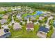 An aerial view showcases a suburban neighborhood with well-maintained lawns and winding ponds at 10720 Breaking Rocks Dr, Tampa, FL 33647