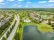 Aerial view showcasing a community pool with lush landscaping and nearby lake at 10720 Breaking Rocks Dr, Tampa, FL 33647