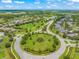 Aerial view of the community with well-manicured landscaping surrounding the roundabout near the park at 10720 Breaking Rocks Dr, Tampa, FL 33647