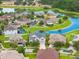 A picturesque aerial view of a residential neighborhood with manicured lawns and tranquil ponds at 10720 Breaking Rocks Dr, Tampa, FL 33647