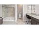 Bathroom with walk in shower, vanity, tile floor, and lots of counter space at 10720 Breaking Rocks Dr, Tampa, FL 33647