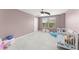 Bedroom with crib and a large window providing natural light at 10720 Breaking Rocks Dr, Tampa, FL 33647