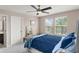 Bedroom with a large bed, bench, and windows showcasing the outdoor view at 10720 Breaking Rocks Dr, Tampa, FL 33647
