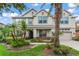 Charming two-story home with landscaped yard, stone accents, and a welcoming front porch at 10720 Breaking Rocks Dr, Tampa, FL 33647
