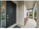 Inviting front porch features stone accents, decorative glass door, and a tiled walkway at 10720 Breaking Rocks Dr, Tampa, FL 33647