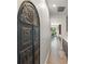 Hallway featuring an ornate accent door, with views to the kitchen and dining room at 10720 Breaking Rocks Dr, Tampa, FL 33647