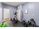Dedicated home gym space with various exercise equipment and soft rubber floor for workouts and floor exercises at 10720 Breaking Rocks Dr, Tampa, FL 33647