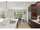 Bright kitchen with stainless steel appliances, dark cabinetry, quartz countertops, and a breakfast nook overlooking the pool at 10720 Breaking Rocks Dr, Tampa, FL 33647