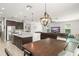 Open floor plan showing the kitchen island with stainless appliances and quartz countertops, breakfast nook, and living room at 10720 Breaking Rocks Dr, Tampa, FL 33647