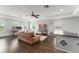 Cozy living room features hardwood floors, comfortable leather furniture, and plenty of natural light from large windows at 10720 Breaking Rocks Dr, Tampa, FL 33647