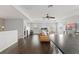 Bright open-concept living area featuring dark hardwood floors and modern ceiling fan at 10720 Breaking Rocks Dr, Tampa, FL 33647