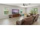 Bright living room with comfortable seating, large windows, and neutral tones at 10720 Breaking Rocks Dr, Tampa, FL 33647