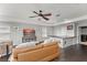 Inviting living room with a flat screen tv, dark countertops, and sleek ceiling fan at 10720 Breaking Rocks Dr, Tampa, FL 33647