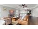 Well-lit living room with modern furniture, hardwood floors, and kitchen access at 10720 Breaking Rocks Dr, Tampa, FL 33647