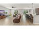Spacious living room with sectional sofa, tile floors, and natural light at 10720 Breaking Rocks Dr, Tampa, FL 33647